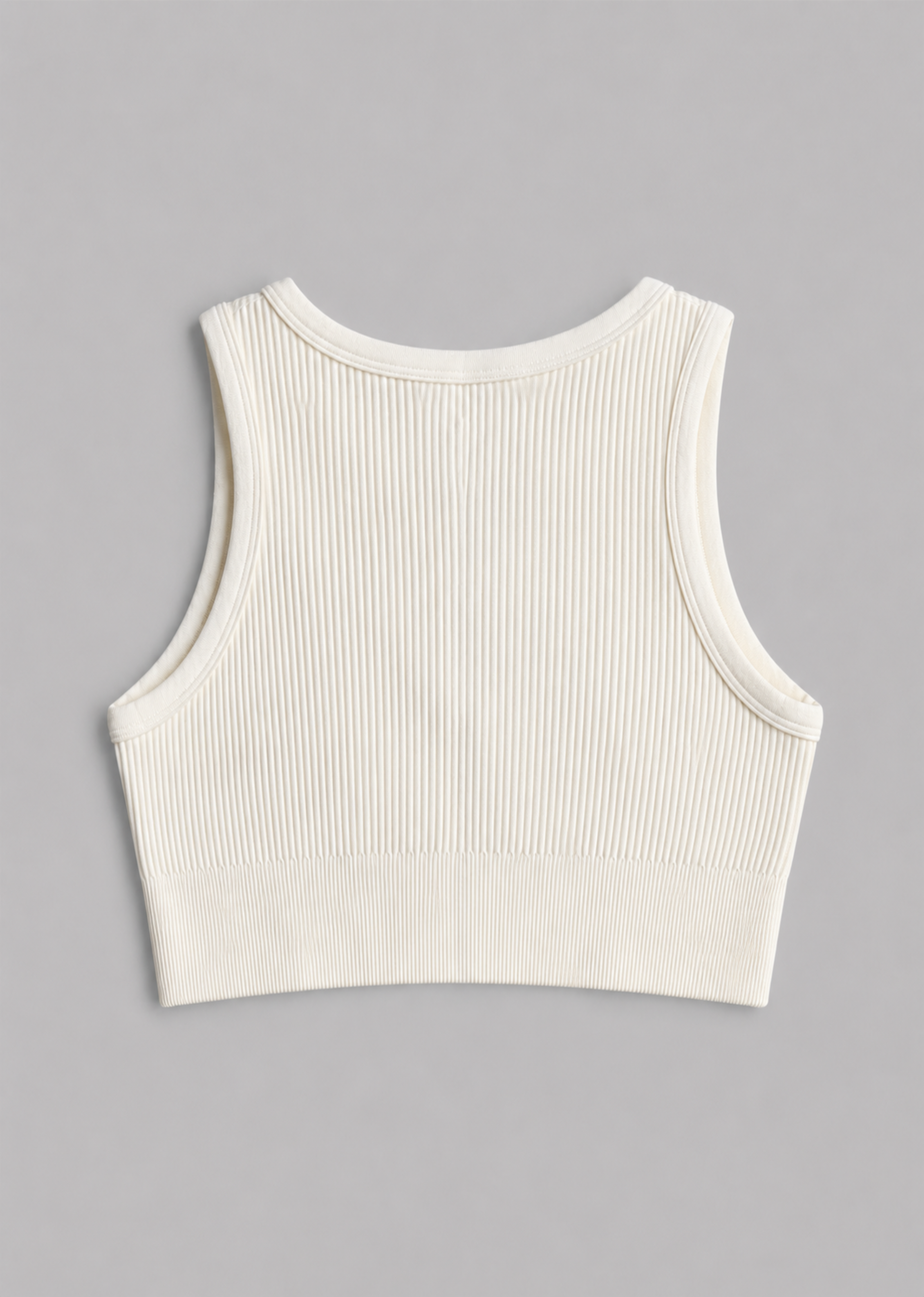 An off-white ribbed knit sleeveless crop top shown from the back, laid flat on a neutral gray background.
