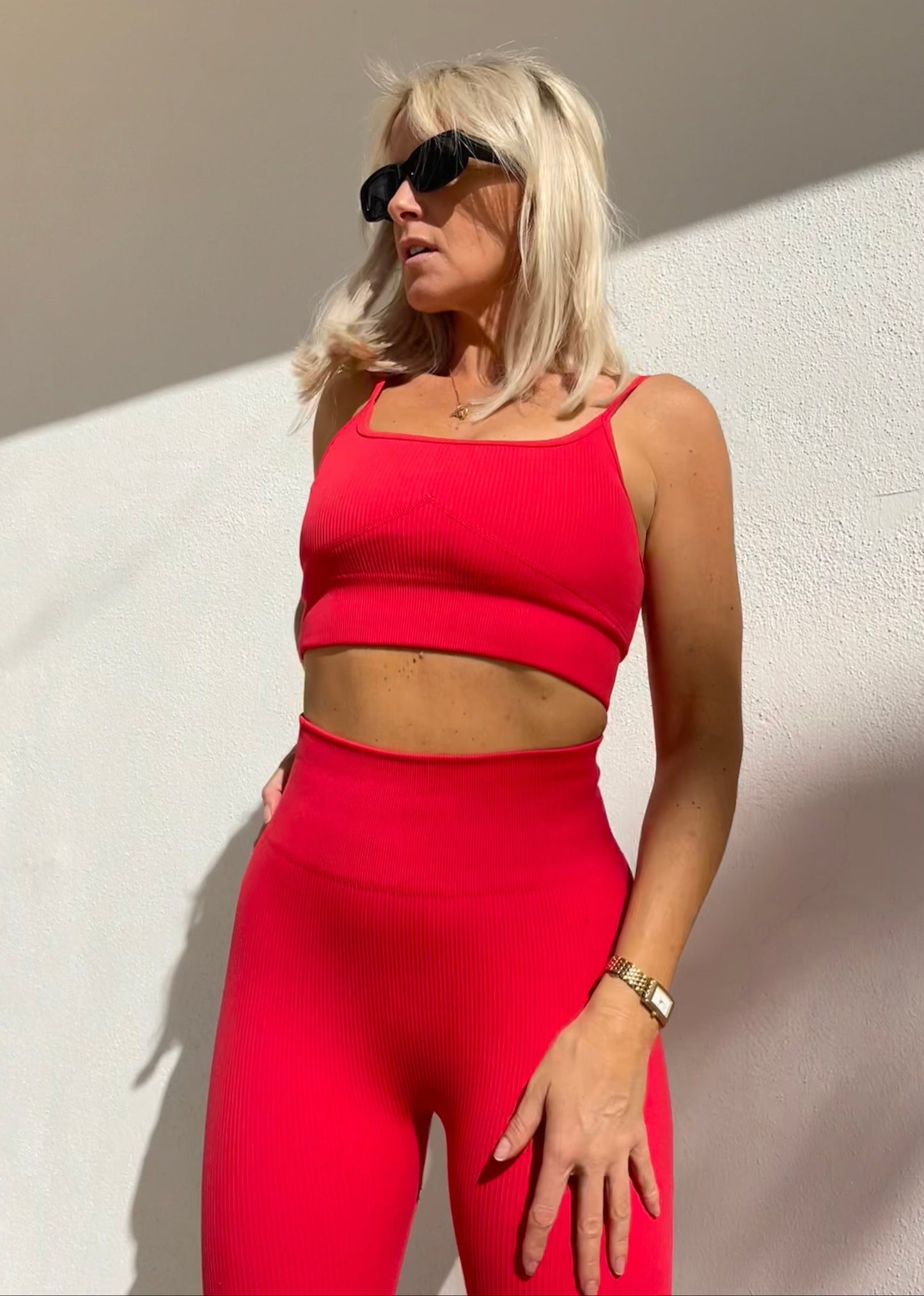 Model wearing Amber Maxwell Marina crimson crop top with adjustable straps.